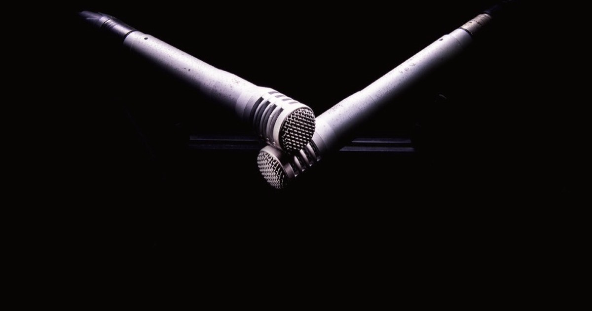 Several studio microphones mounted on stands.