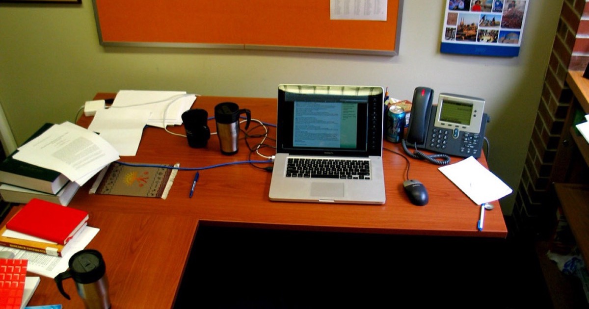 A laptop open on an office desk.